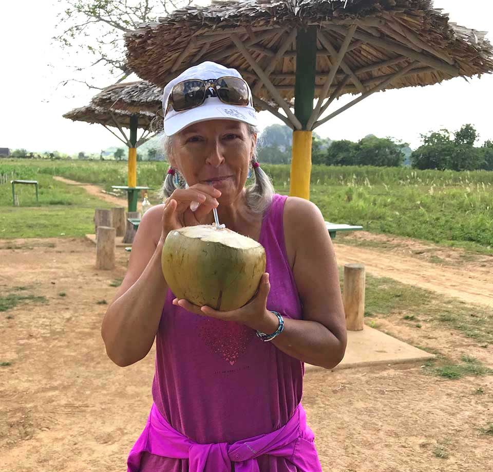 Heidi with drinking coconut in Viñales